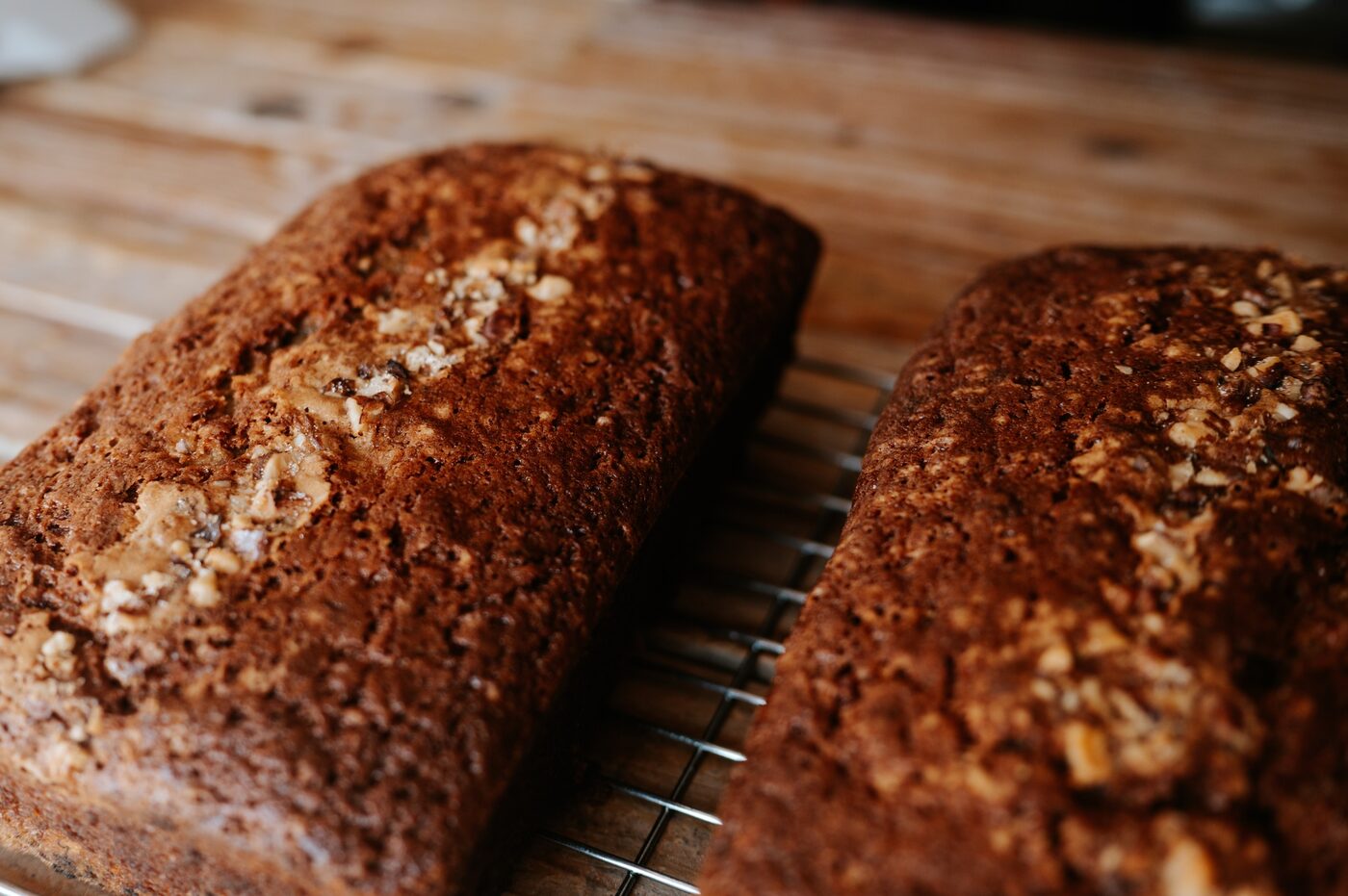 Two freshly baked loaves cooling on a rack