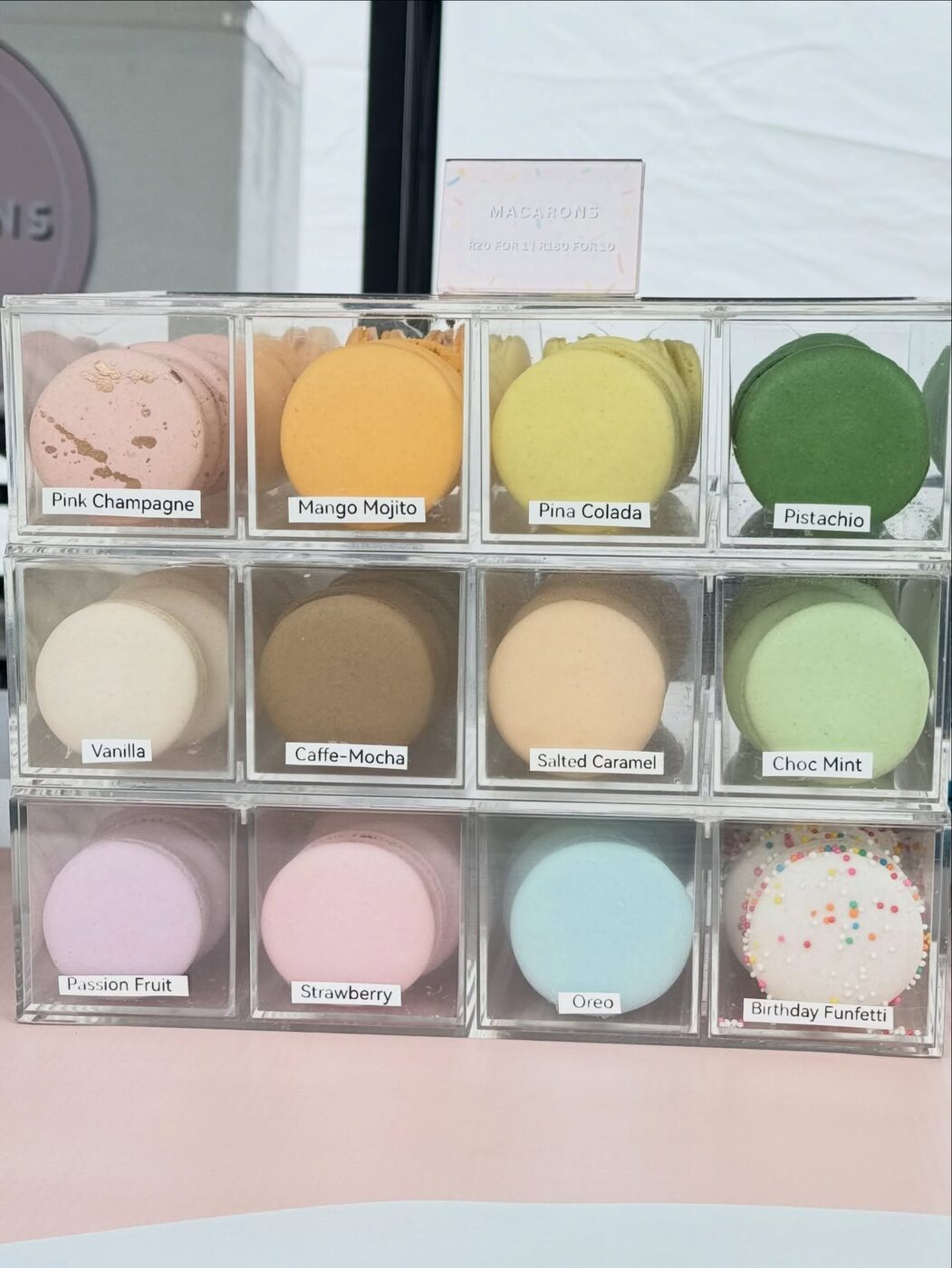 A display case of pastel macarons