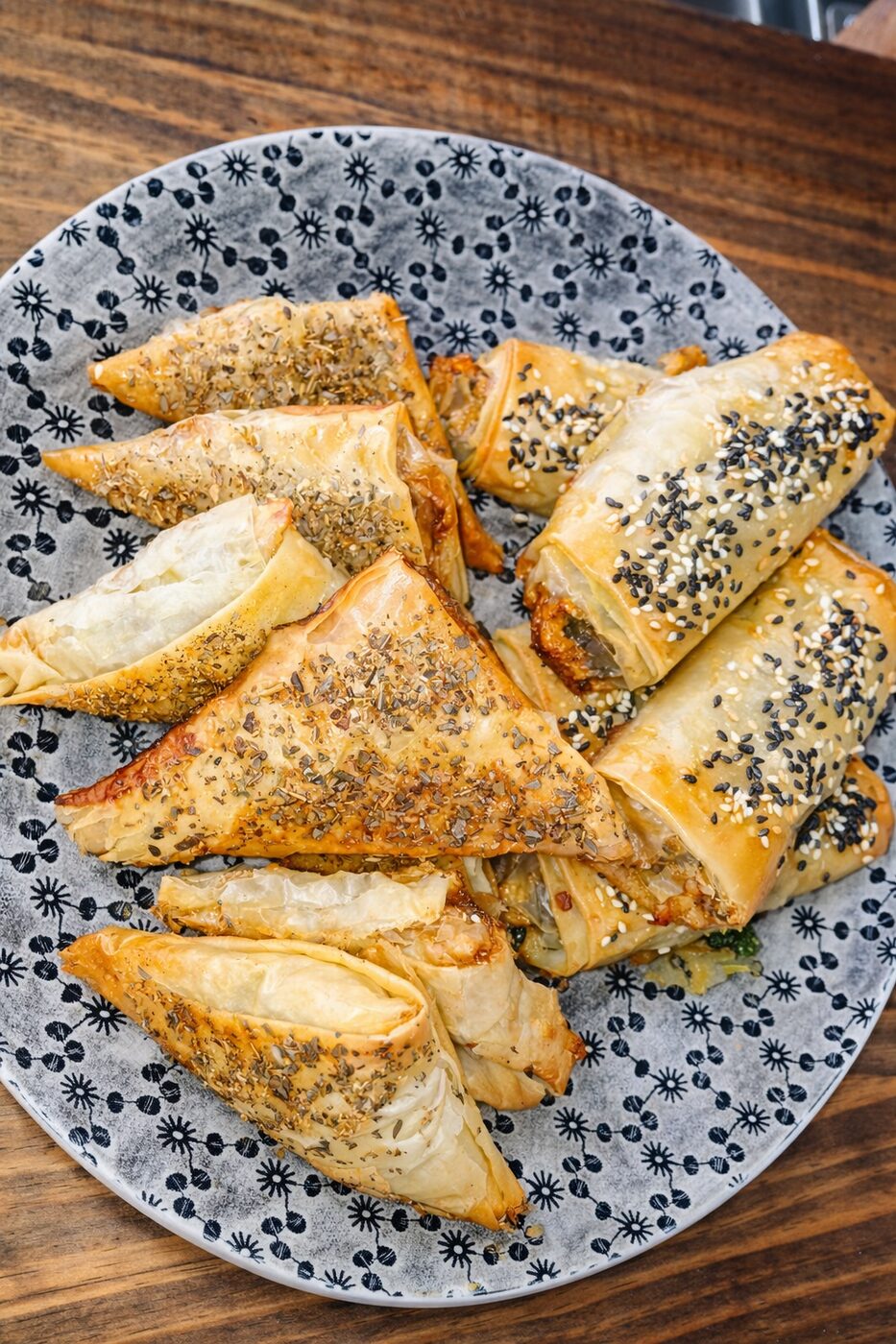 Golden savoury filo parcels on a patterned plate